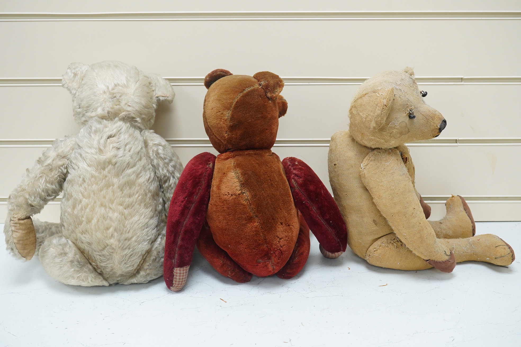 Three bears, one Chiltern 1950's. Condition - good, missing eyes, height 46cm, 1930's plush ear, button eyes. Condition - faded, height 42cm, 1930's bear, height 40cm. Condition - poor.